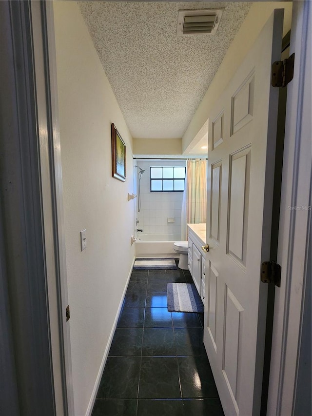 full bath with visible vents, toilet, shower / tub combo, tile patterned floors, and a textured ceiling