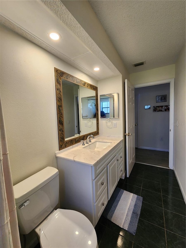 bathroom featuring vanity, visible vents, tile patterned flooring, a textured ceiling, and toilet