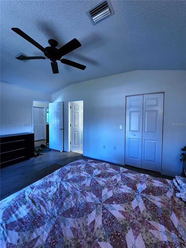 unfurnished bedroom with visible vents, a ceiling fan, a textured ceiling, a closet, and lofted ceiling