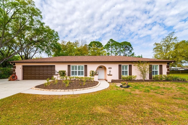 ranch-style home with stucco siding, an attached garage, driveway, and a front lawn