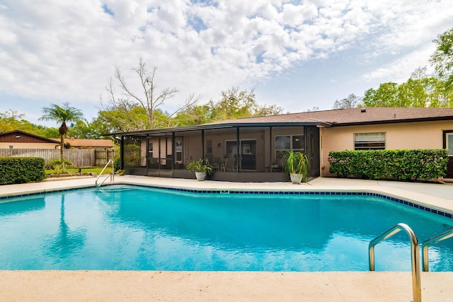 view of pool featuring a fenced in pool, fence, and a sunroom