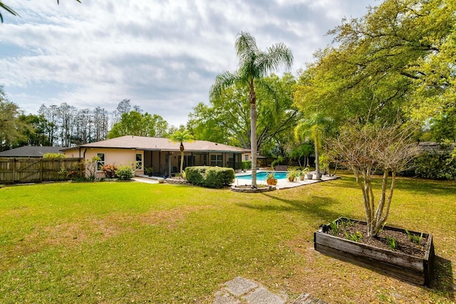 view of yard with a fenced in pool, a vegetable garden, and fence