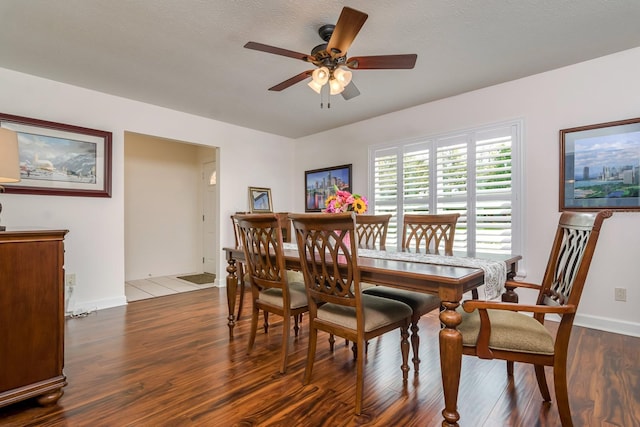 dining room with baseboards, wood finished floors, and a ceiling fan