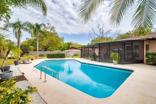 view of pool with a patio area, a fenced backyard, a fenced in pool, and a sunroom