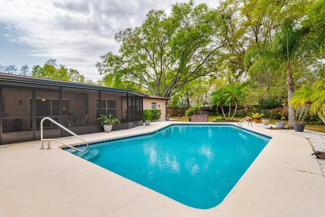 view of pool with a fenced in pool, a patio, fence, and a sunroom