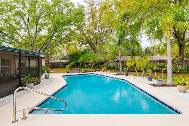 view of swimming pool with a fenced in pool, a fenced backyard, and a patio area