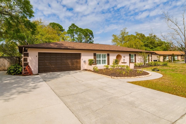 single story home with fence, a garage, driveway, and stucco siding