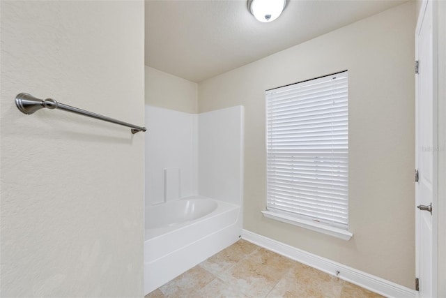 full bath with bathtub / shower combination, tile patterned floors, and baseboards