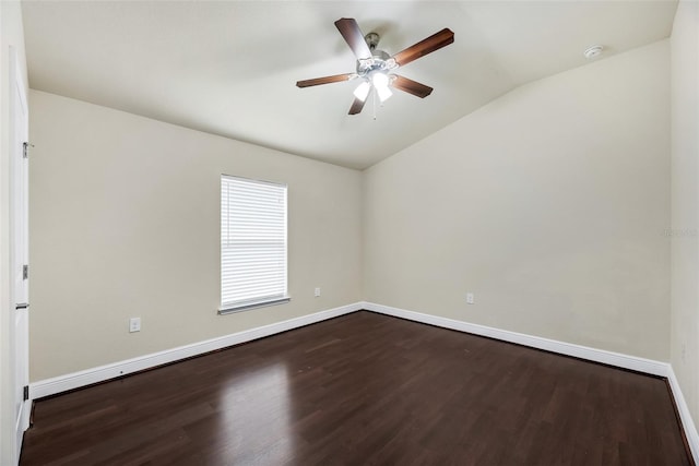 unfurnished room with lofted ceiling, baseboards, dark wood-type flooring, and ceiling fan