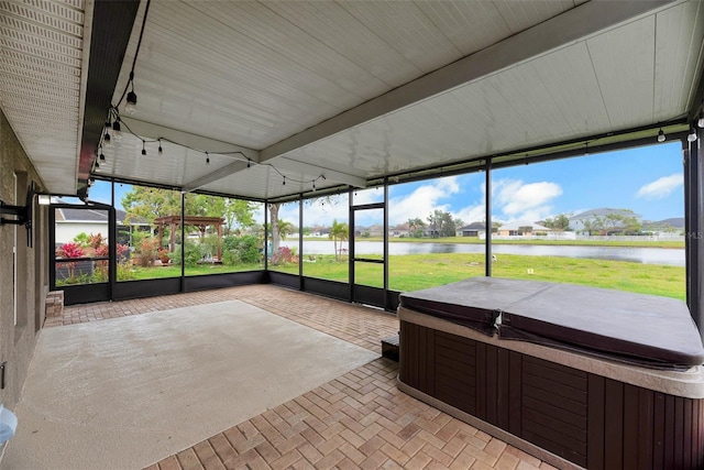 unfurnished sunroom featuring a water view