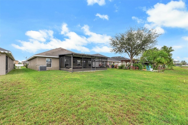 view of yard with a sunroom and central AC