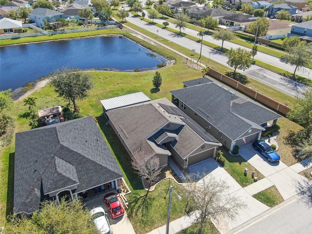 birds eye view of property with a residential view and a water view