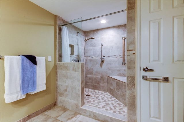 full bath with a tile shower