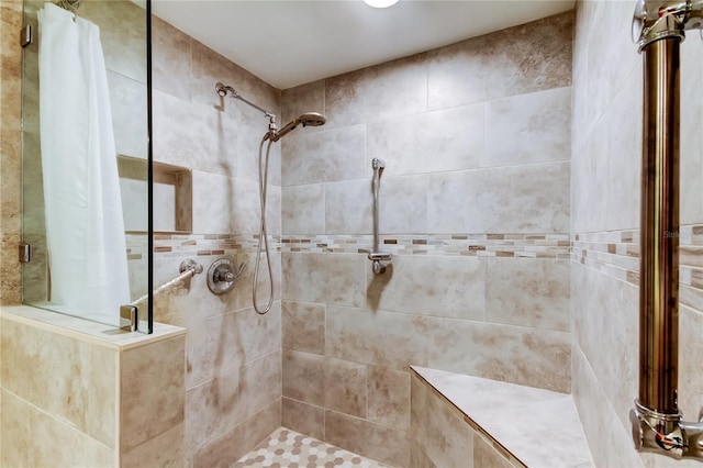 bathroom with tiled shower