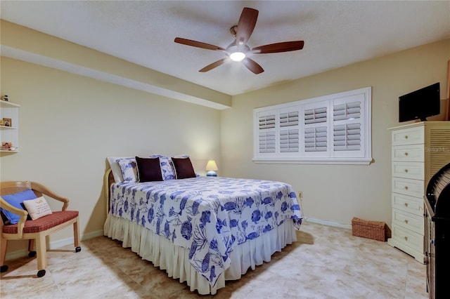 bedroom featuring a ceiling fan and baseboards