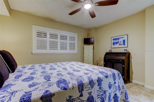 bedroom with ceiling fan and baseboards