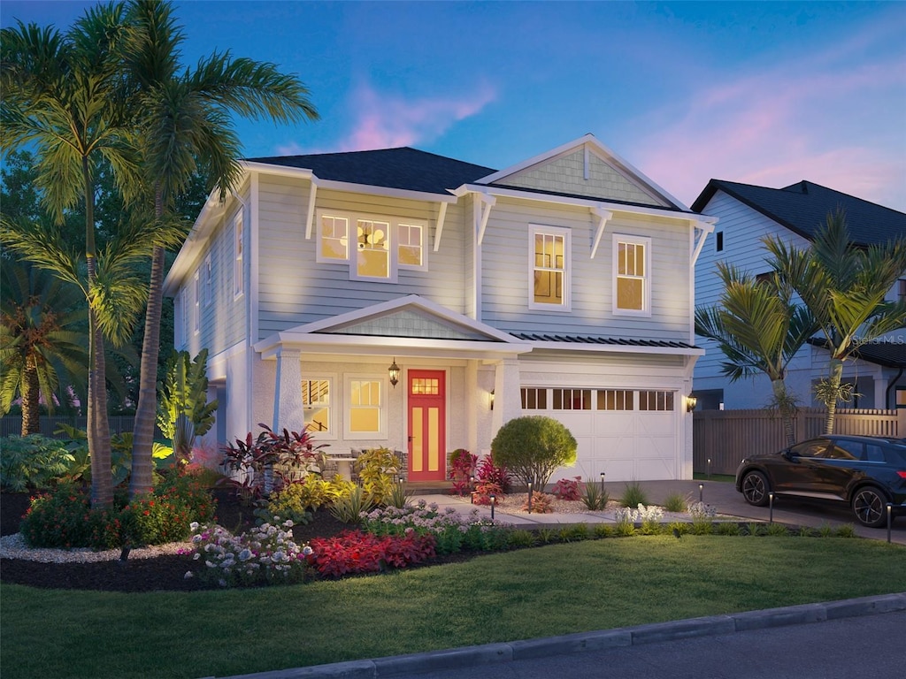 view of front facade with a garage, a lawn, driveway, and fence