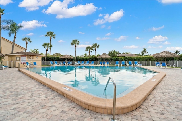 community pool featuring a patio and fence