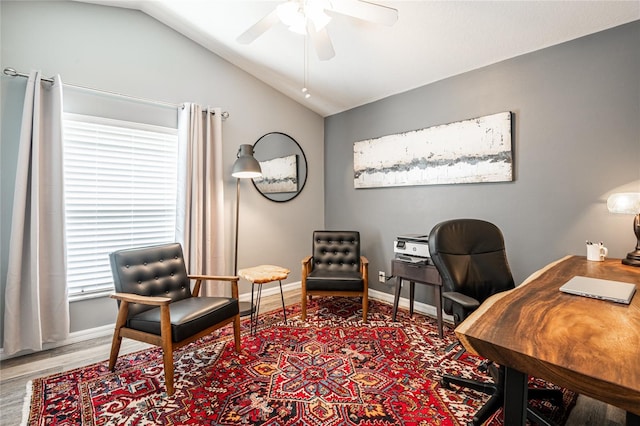 office area featuring vaulted ceiling, wood finished floors, baseboards, and ceiling fan