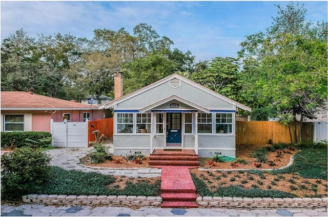 view of front of property featuring crawl space, entry steps, a chimney, and fence