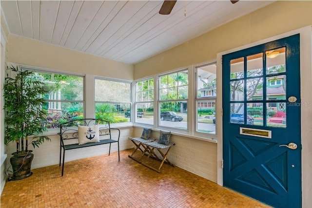 sunroom / solarium with a wealth of natural light, wood ceiling, and ceiling fan