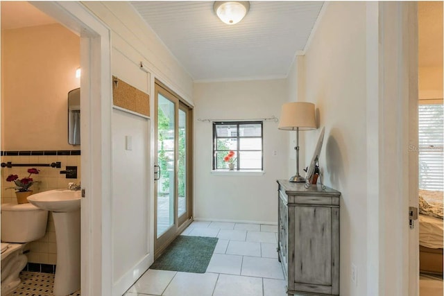 entryway featuring light tile patterned flooring and tile walls