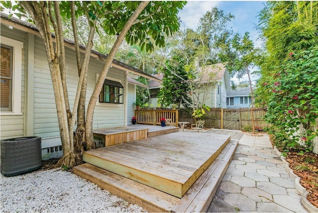 wooden deck featuring central AC unit and fence