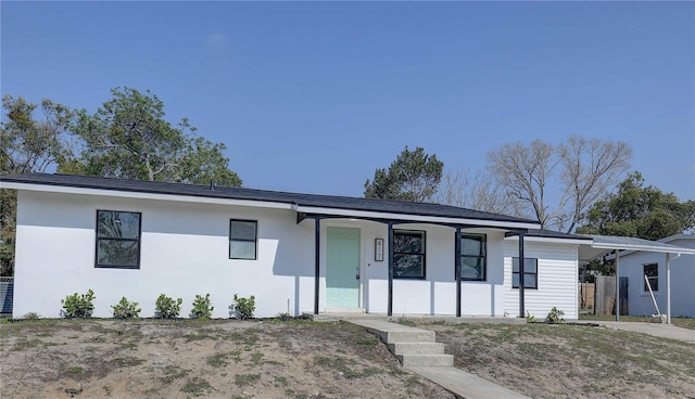 view of front of property featuring covered porch and stucco siding