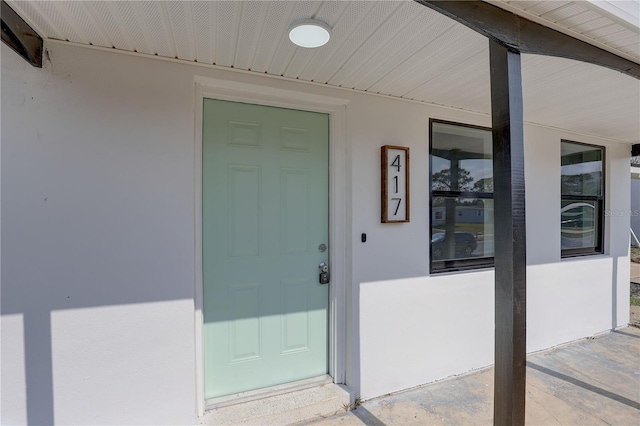 doorway to property with stucco siding