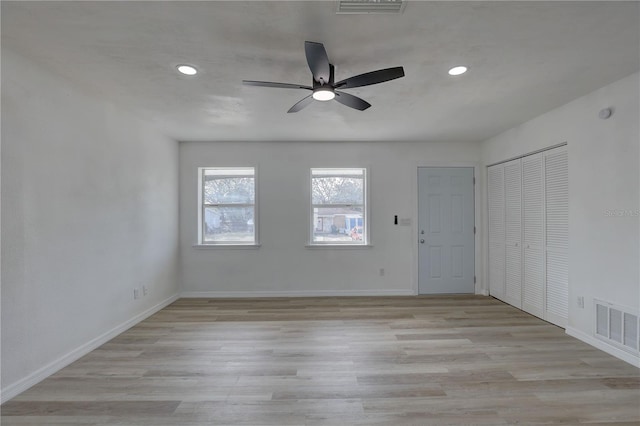 unfurnished room featuring recessed lighting, baseboards, visible vents, and light wood-type flooring