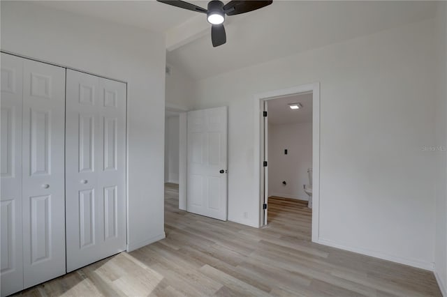 unfurnished bedroom featuring light wood-style flooring, lofted ceiling with beams, a closet, baseboards, and ceiling fan