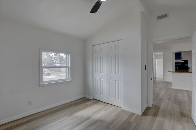 unfurnished bedroom featuring visible vents, baseboards, a closet, and light wood-style flooring