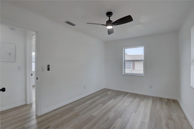 empty room with light wood-style flooring, baseboards, visible vents, and ceiling fan