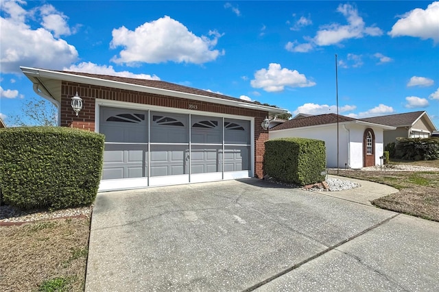 3943 W Fieldwood Ct, Lecanto, FL 34461 - view of front of house with brick siding, driveway, and a garage