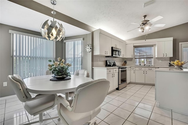 3943 W Fieldwood Ct, Lecanto, FL 34461 - kitchen featuring appliances with stainless steel finishes, light countertops, white cabinets, a ceiling fan, and tasteful backsplash