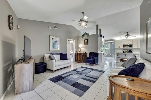 3943 W Fieldwood Ct, Lecanto, FL 34461 - living room featuring ceiling fan, vaulted ceiling, light tile patterned flooring, and baseboards