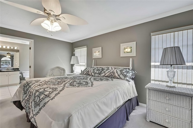3943 W Fieldwood Ct, Lecanto, FL 34461 - bedroom featuring light colored carpet, baseboards, a sink, ensuite bathroom, and ornamental molding