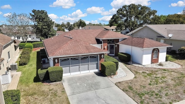 3943 W Fieldwood Ct, Lecanto, FL 34461 - view of front of home featuring driveway, a garage, a front yard, brick siding, and central AC