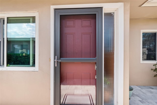 property entrance featuring stucco siding