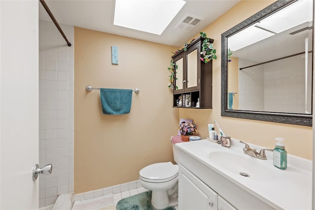 bathroom with tile patterned floors, visible vents, toilet, and walk in shower