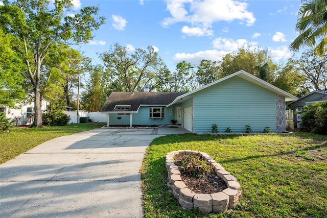 view of front of property featuring driveway, a front yard, and fence