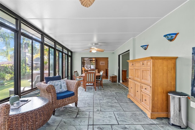 sunroom / solarium featuring ceiling fan