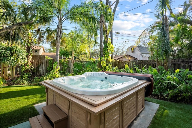 exterior space with a hot tub and fence