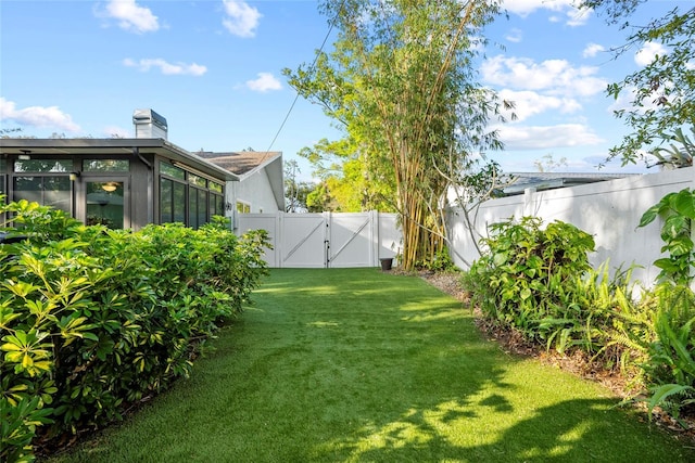 view of yard with a gate and a fenced backyard