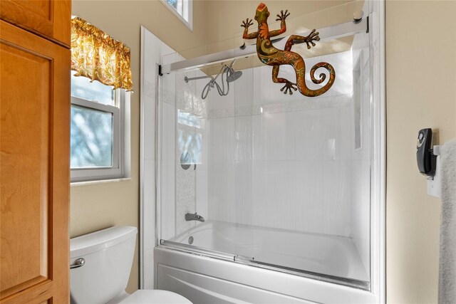 9466 127th Ave, Largo, FL 33773 - full bathroom featuring toilet and shower / bath combination with glass door