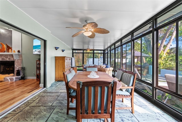 9466 127th Ave, Largo, FL 33773 - sunroom featuring stone tile flooring, a ceiling fan, healthy amount of natural light, and floor to ceiling windows
