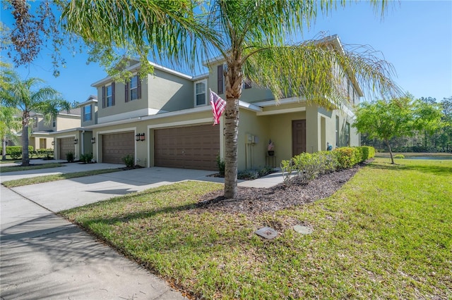 view of front of home featuring stucco siding, a garage, concrete driveway, and a front lawn