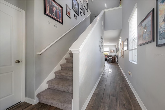 stairway with baseboards and wood finished floors