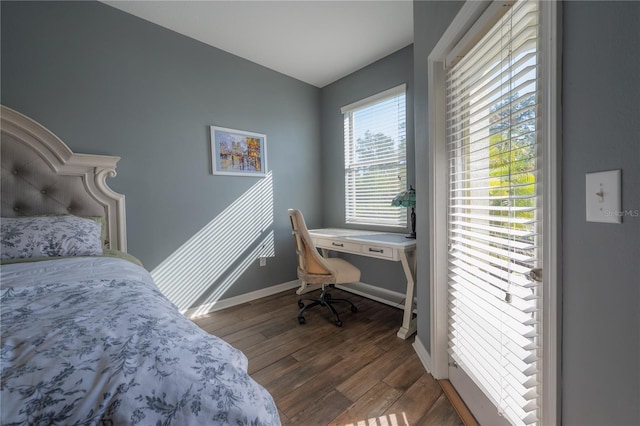 bedroom with wood finished floors and baseboards