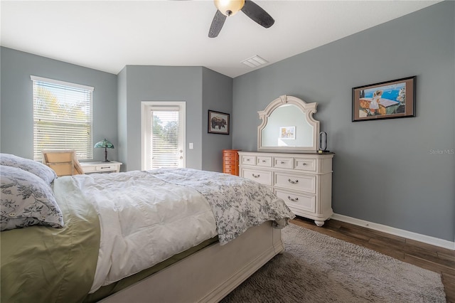 bedroom with dark wood-type flooring, baseboards, visible vents, and ceiling fan